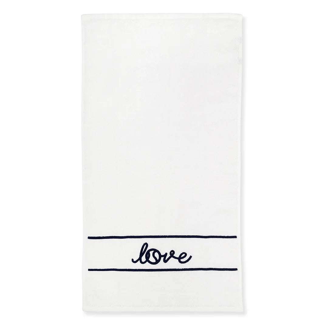 A white tennis towel with the word 'love' embroidered in navy, with a white background