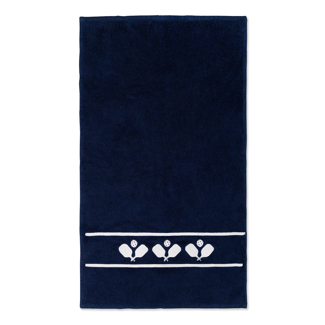 A navy tennis towel with pickleball paddles embroidered in white , with a white background
