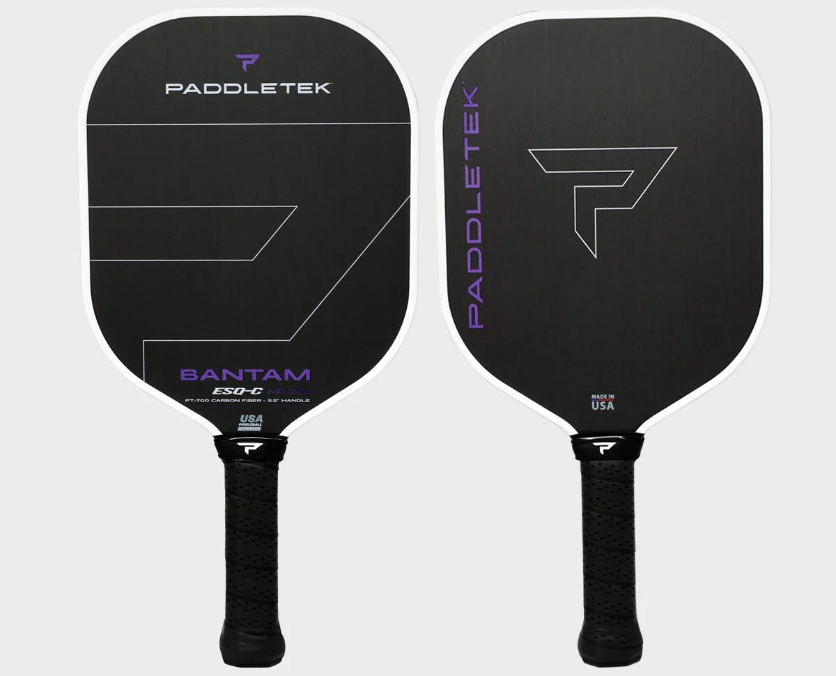 Back paddletek pickleball paddle lined with purple with purple lettering written on the side and bottom. Shown on a white background.