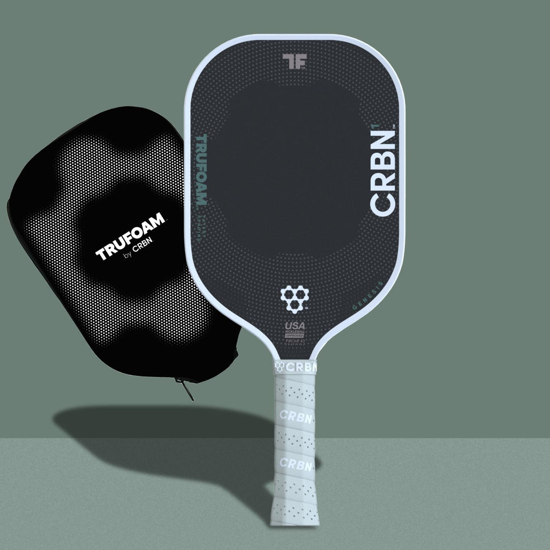 A black and green CRBN Tru Foam Genesis Hybrid 14mm paddle with a foam core, alongside a black carrying case. The paddle features geometric patterns and branding details in white and green colors.