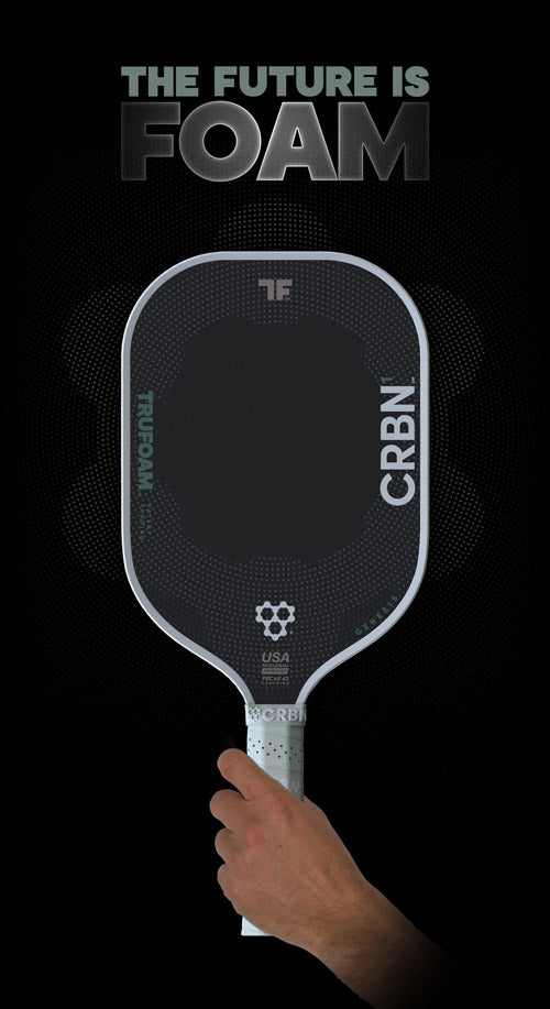 A black and green CRBN Tru Foam Genesis Hybrid 14mm paddle with a foam core, alongside a black carrying case. The paddle features geometric patterns and branding details in white and green colors.