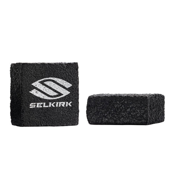 Two black cleaning blocks with a white logo on a white background