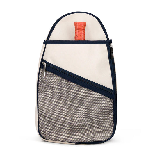 A canvas pickleball sling bag with adjustable strap, featuring a natural color on the bottom and navy color on the top, with an exterior front mesh pocket and a zippered closure.