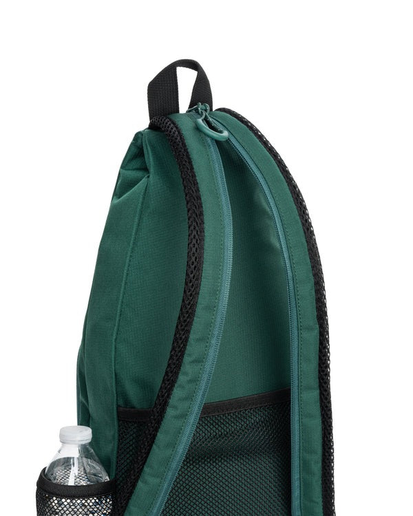 Green backpack with a water bottle pocket on a white background