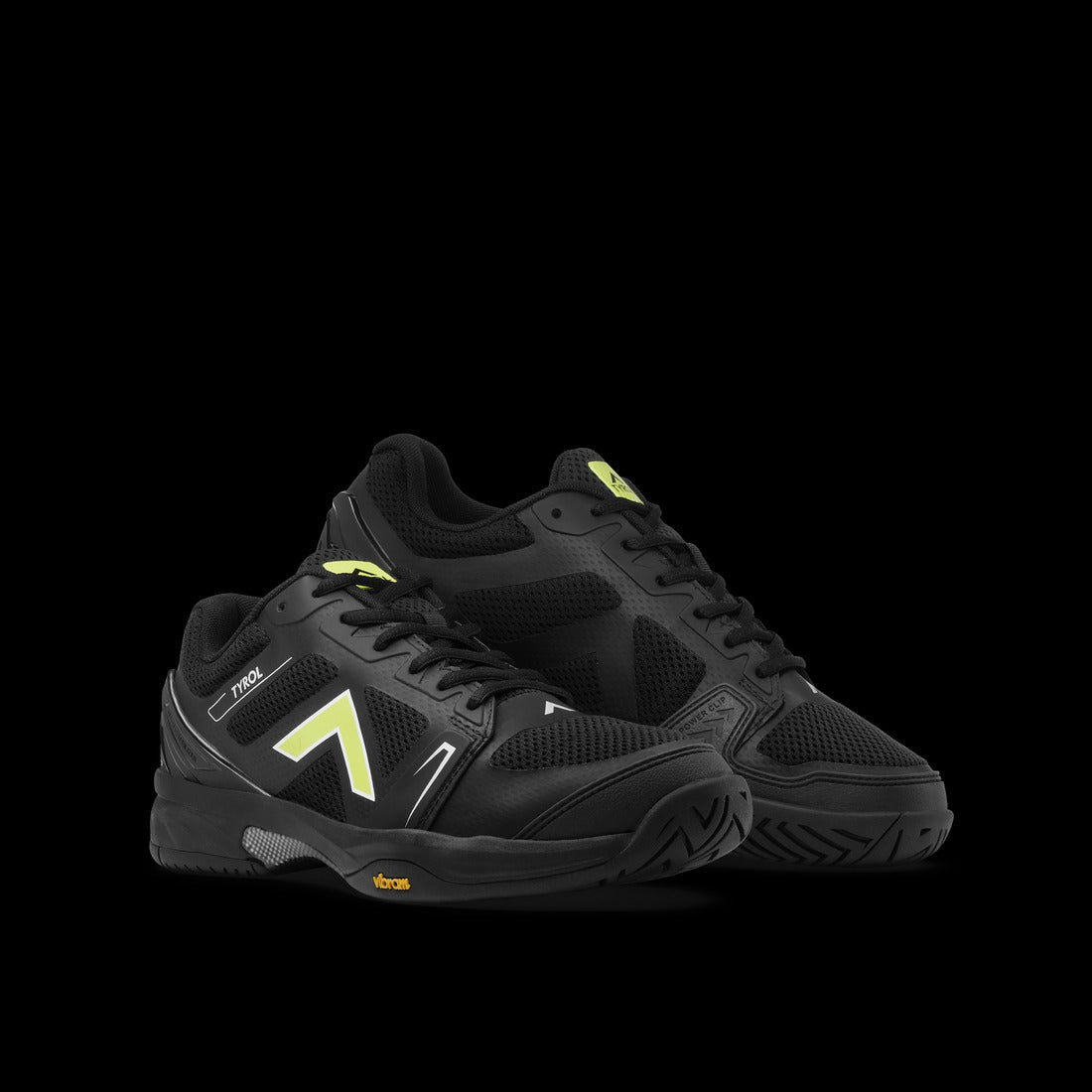 Black athletic shoes with yellow accents on a black background
