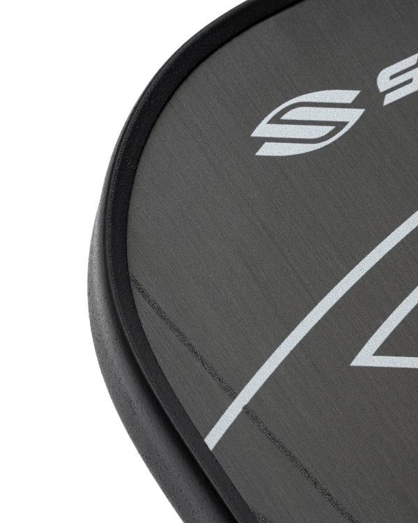Close-up of a black paddle with a logo on a white background