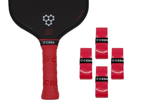 A set of four red overgrips for pickleball paddles with the CRBN logo, displayed with one grip on a black paddle with a visible logo, and the others in a resealable bag.