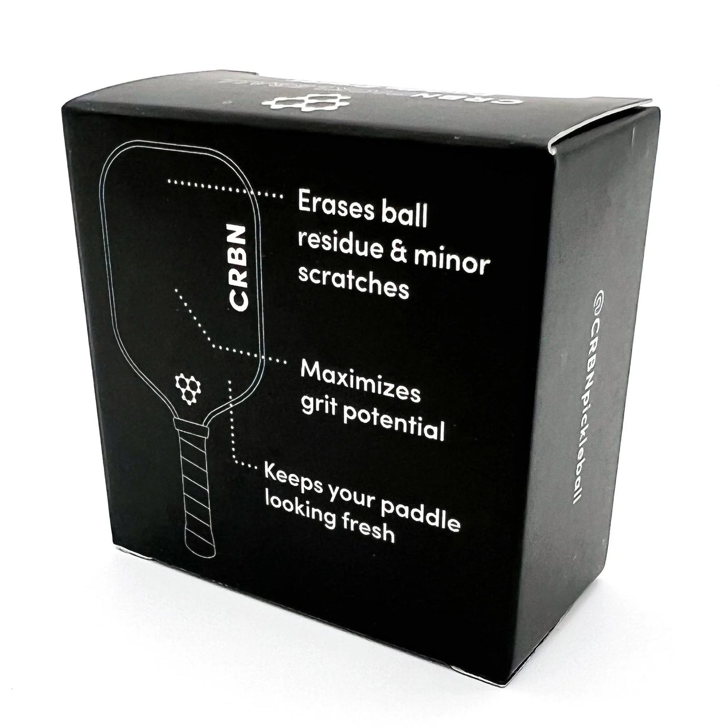 A black CRBN Pickleball Paddle Eraser next to its packaging, which is also black with the product name and branding visible.