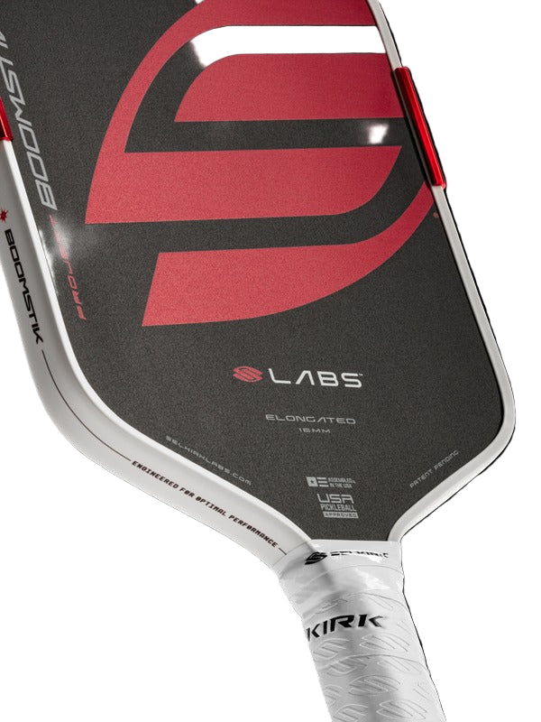 Close-up of a pickleball paddle with visible branding on a white background