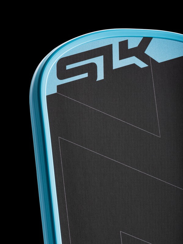 Close up of a selkirk pickleball paddle in black and blue