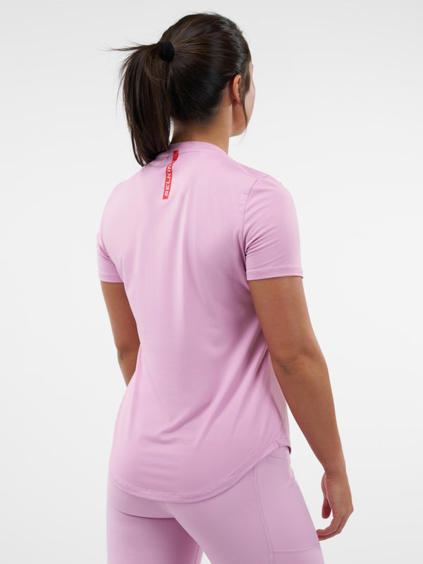 Person wearing a pink athletic outfit on a white background