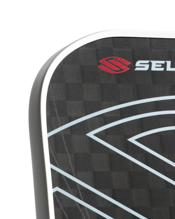 Close-up of a black textured surface with a red and white logo on a white background