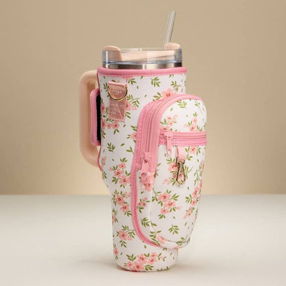 Floral-patterned tumbler holder with pink accents on a beige background