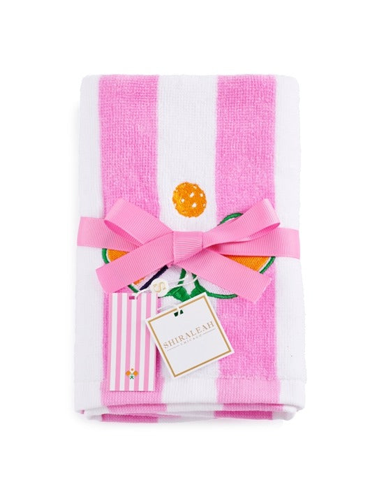 Set of pink and white striped towels with a decorative bow and a tag on a white background
