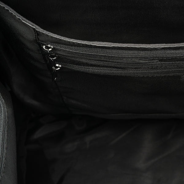 Close-up of a black bag with multiple zippers