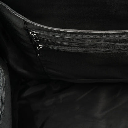 Close-up of a black bag with multiple zippers