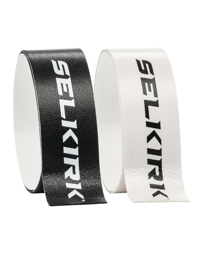 Two rolls of Selkirk tape, one black and one white, on a white background.