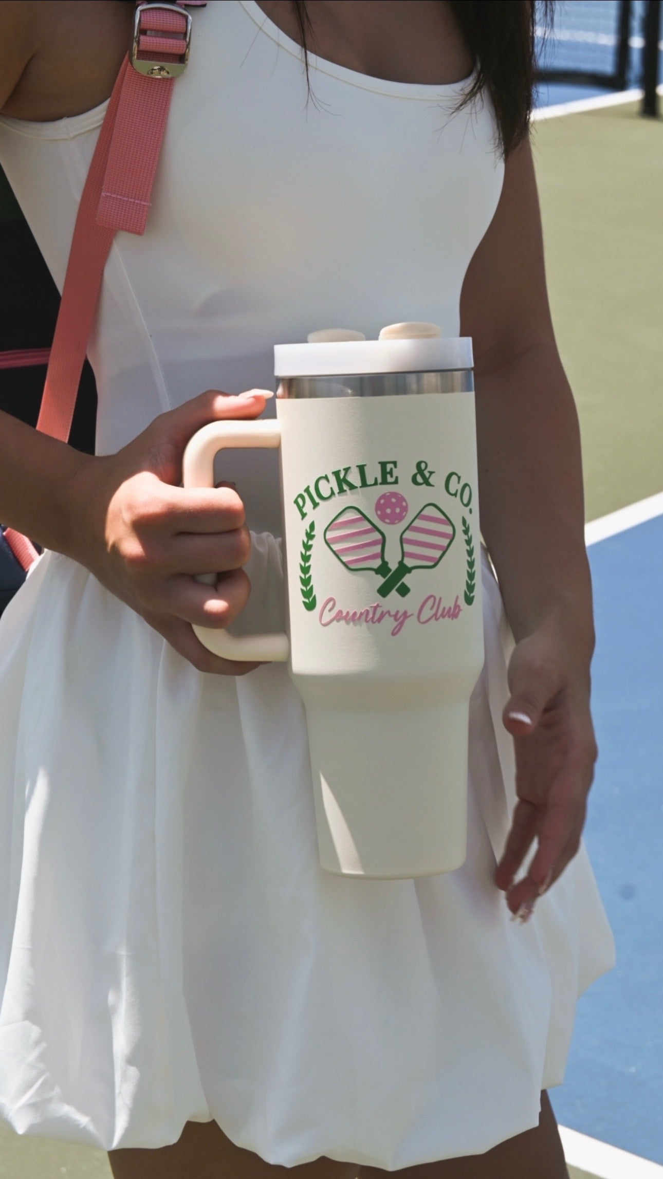 Person holding a white tumbler with 'Pickle & Co Country Club' branding.