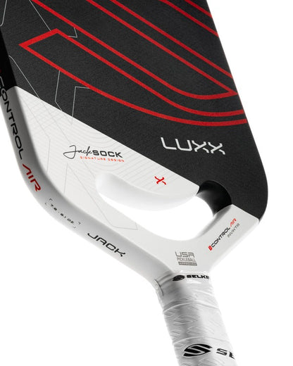 Close-up of a Luxx pickleball paddle with branding on a white background