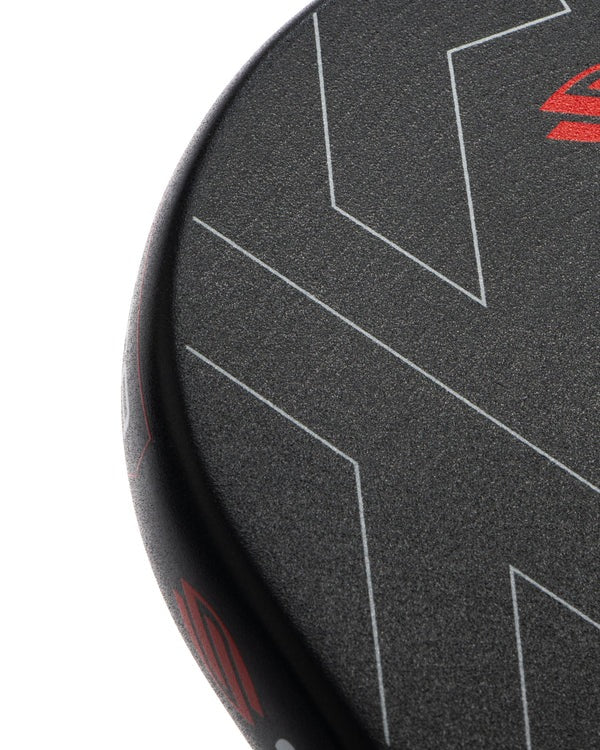 Close-up of a black and red paddle with geometric patterns on a white background