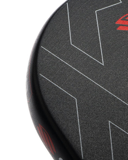 Close-up of a black and red paddle with geometric patterns on a white background