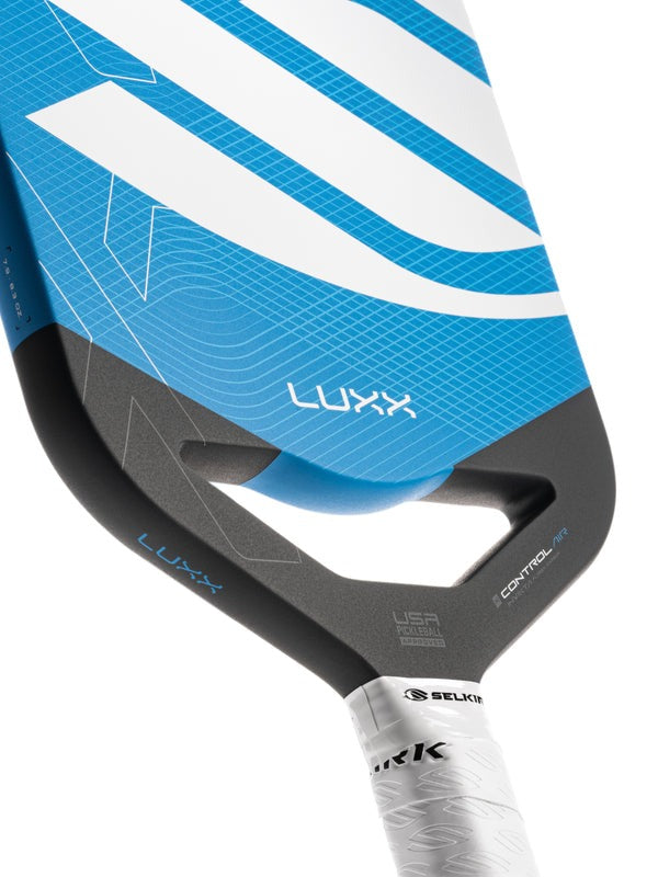 Close-up of a blue and gray paddle with 'Luxx' branding on a white background.
