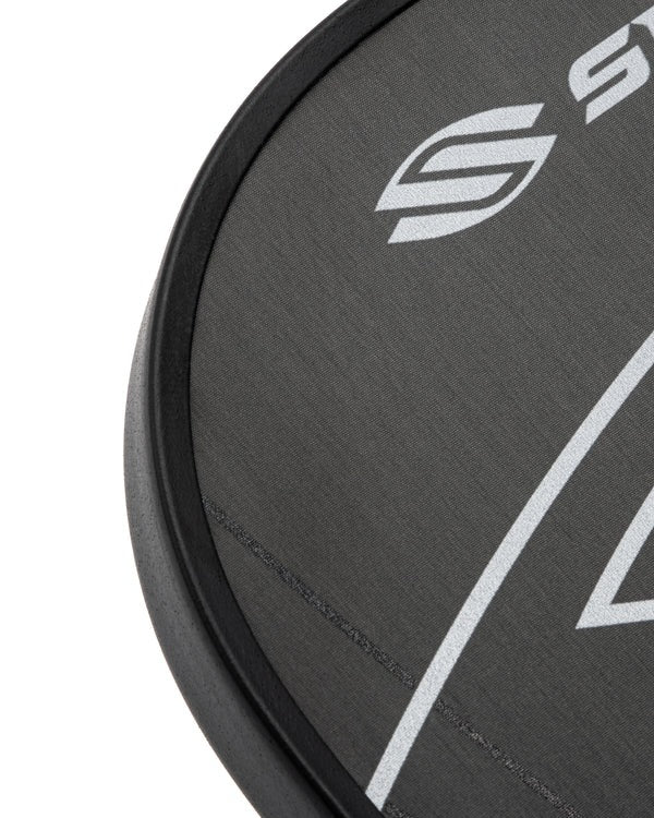 Close-up of a black paddle with a logo on a white background