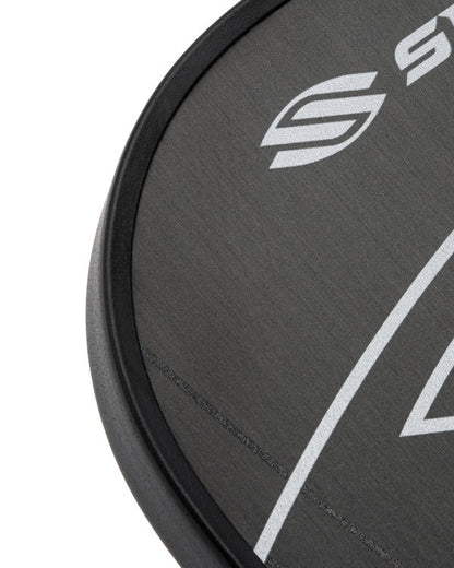 Close-up of a black paddle with a logo on a white background