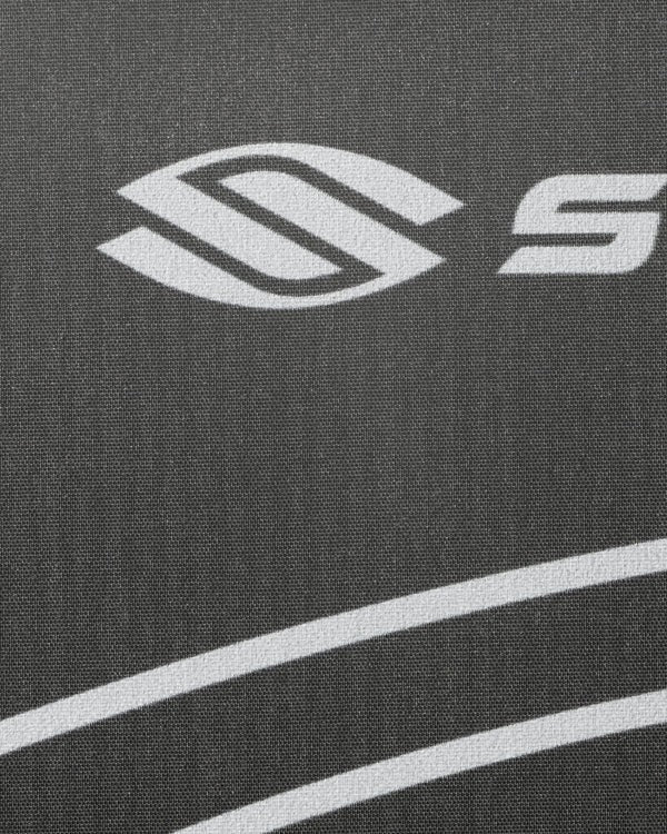 Close-up of a logo on a textured surface with white lines.