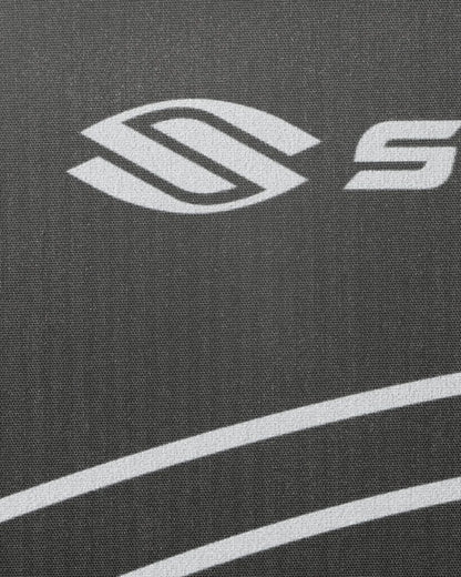 Close-up of a logo on a textured surface with white lines.
