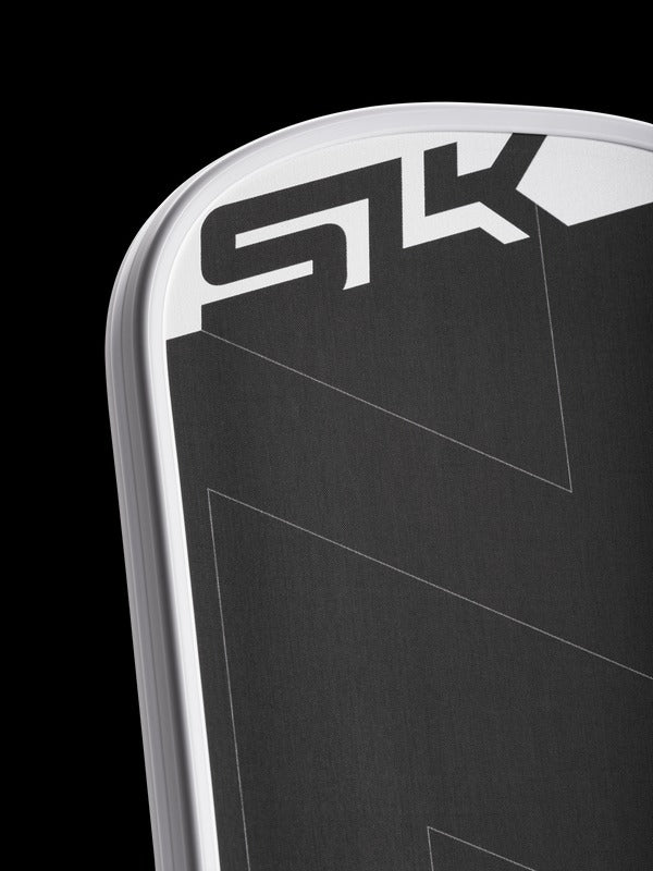 Close-up of a black and silver sports equipment with 'SK' branding on a black background