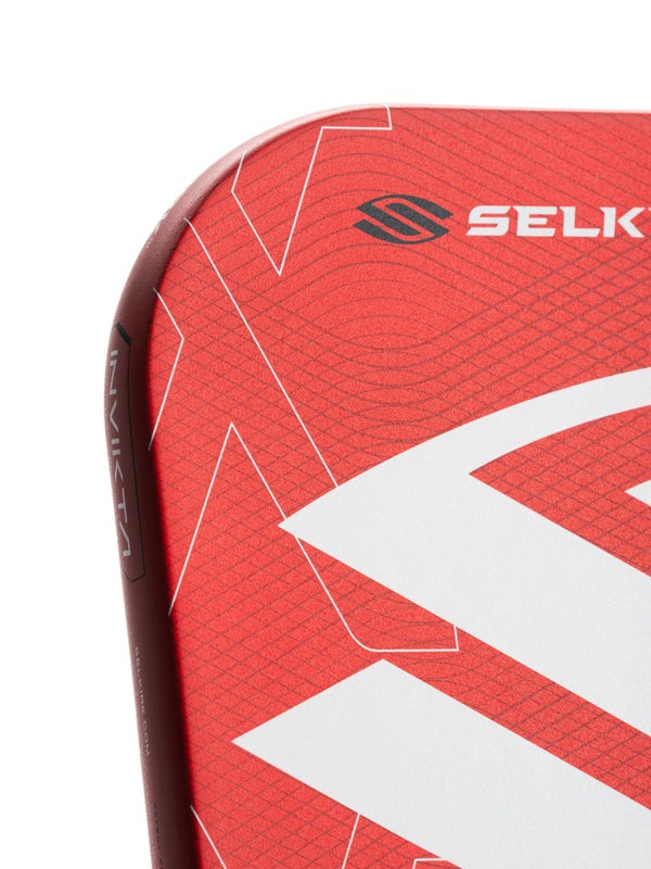 Close-up of a red sports equipment with 'Selk' branding on a white background