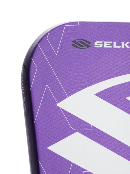 Close-up of a purple sports equipment with 'Selk' branding on a white background