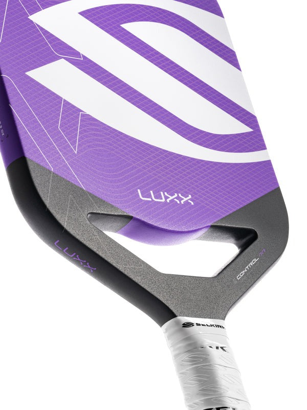 Purple and gray pickleball paddle with 'Luxx' branding on a white background