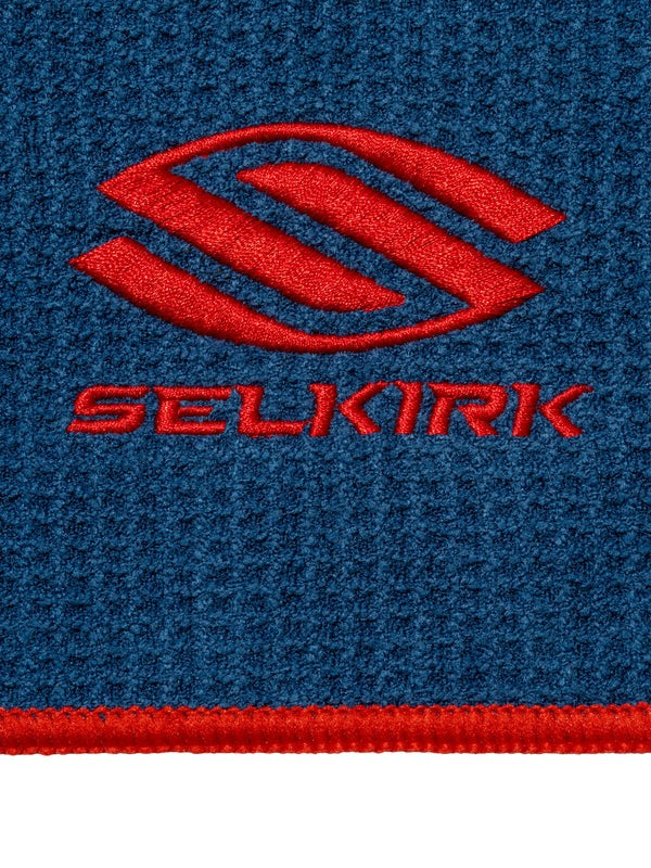 Close-up of a blue fabric with a red Selkirk logo.