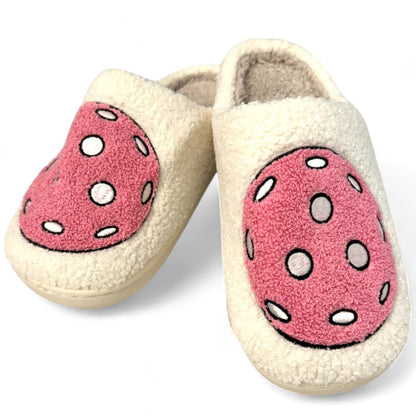 Pair of slippers with pink polka dot design on a white background