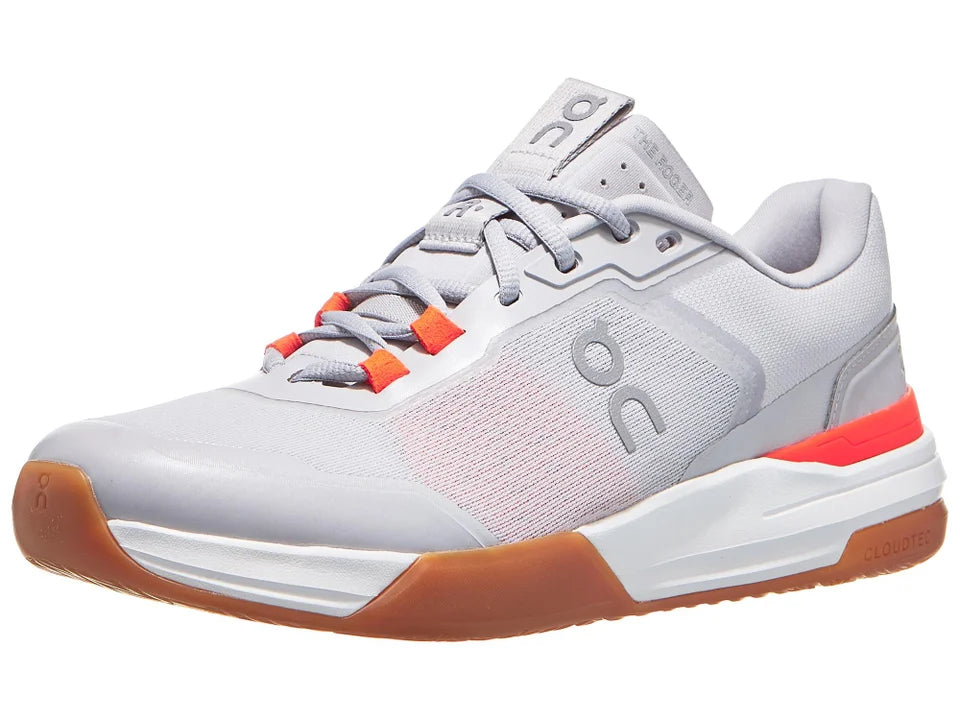 Gray athletic shoe with orange accents on a white background