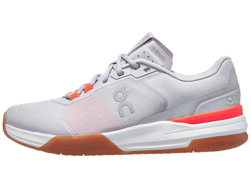 Gray athletic shoe with orange accents on a white background