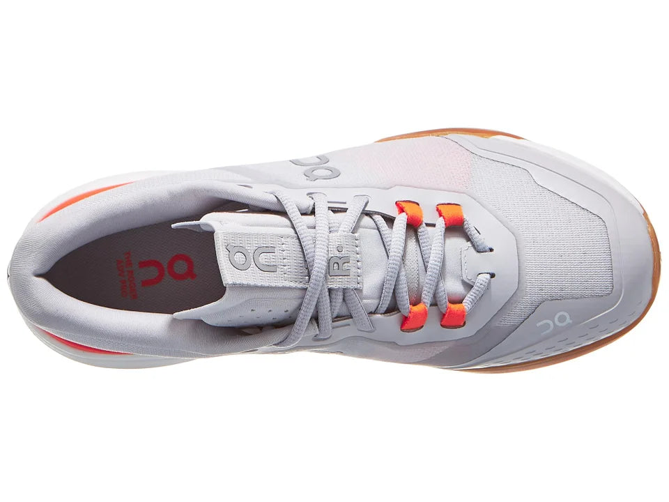 Gray athletic shoe with orange accents on a white background