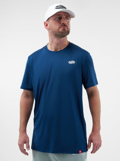 Man wearing a blue t-shirt with a logo on a white background