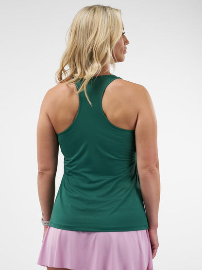 Woman wearing a green tank top and pink skirt on a white background
