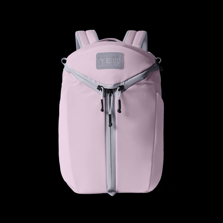Pink backpack with a visible brand logo on a black background