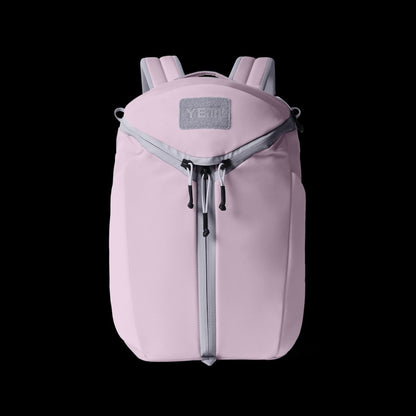 Pink backpack with a visible brand logo on a black background