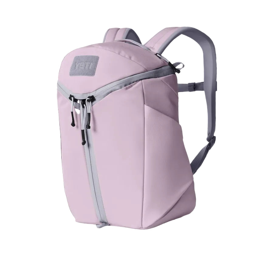 Pink backpack with gray straps on a black background