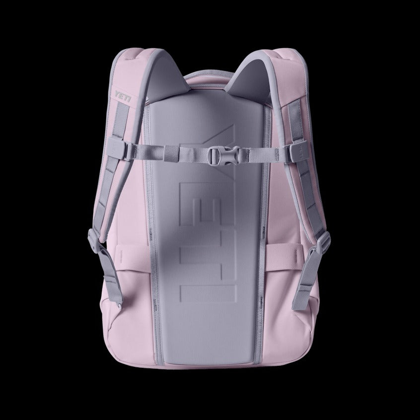 Pink backpack with gray straps on a black background