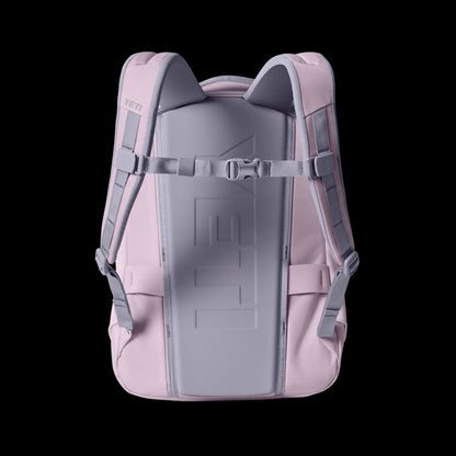 Pink backpack with gray straps on a black background