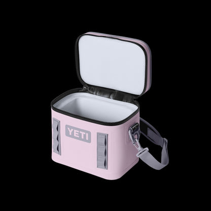 Pink YETI cooler bag with open lid on a black background