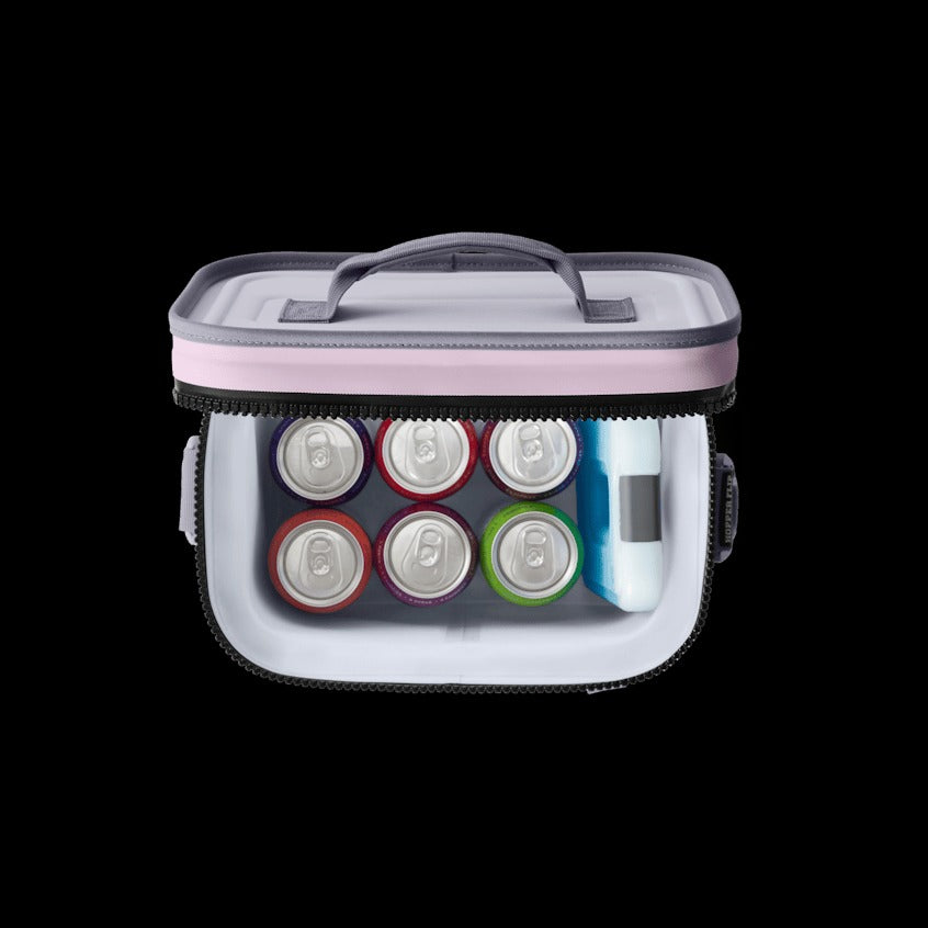 Portable cooler bag with compartments for drinks on a black background